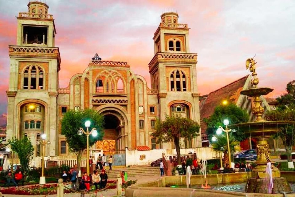 Huaraz Main Square fountain and cathedral at sunset by Andeando Peru